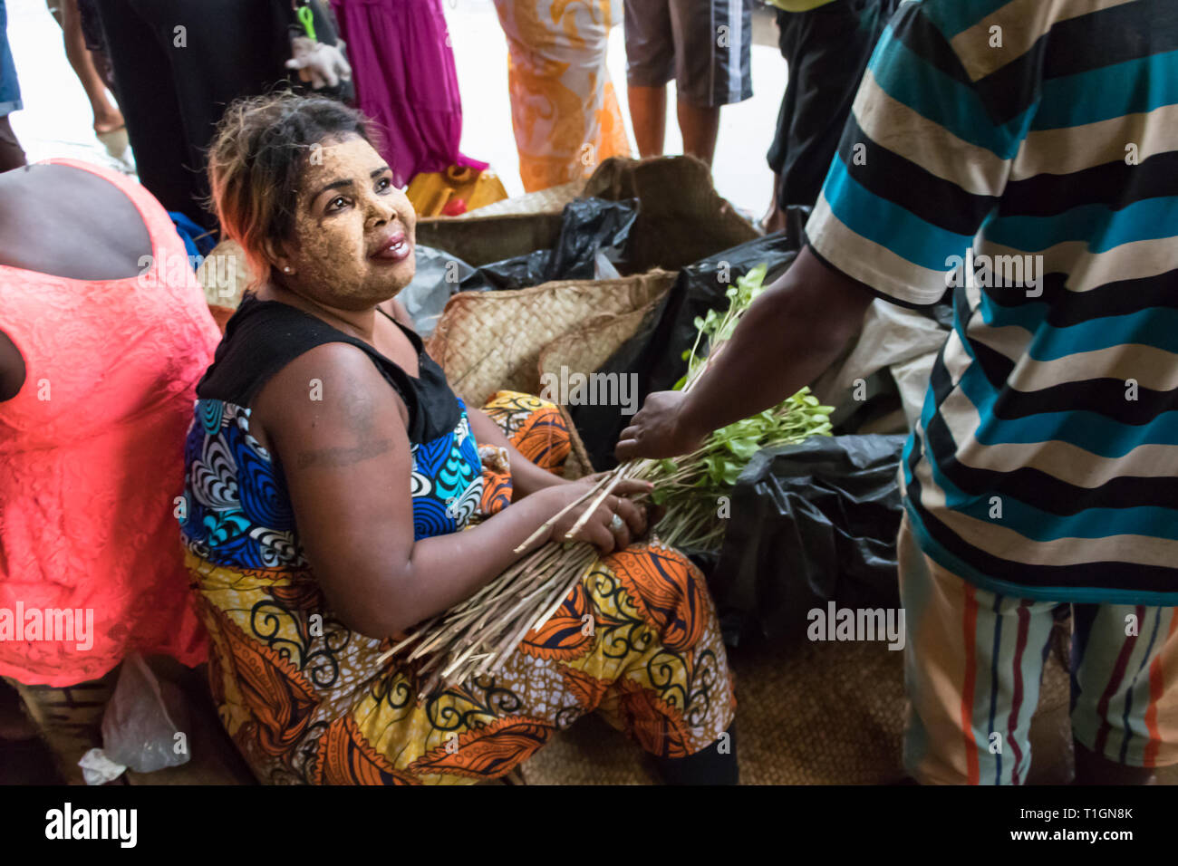 Nosy Be, Madagascar - January 17th, 2019: A woman selling khat in the market of Nosy Be, Madagascar. Stock Photo