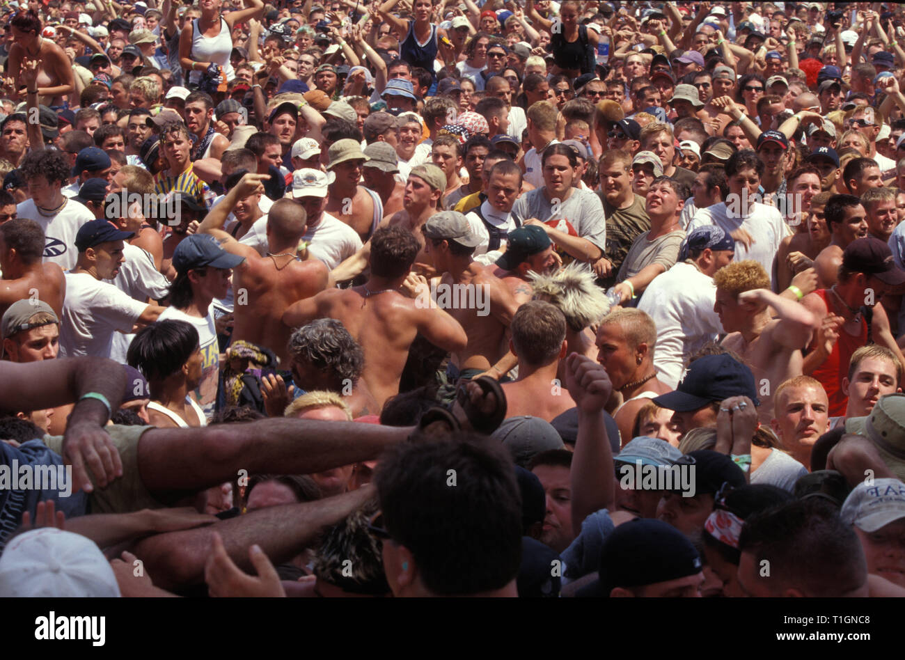 Fans are shown aggressively moshing in the crowd during Woodstock 99 in Rom...