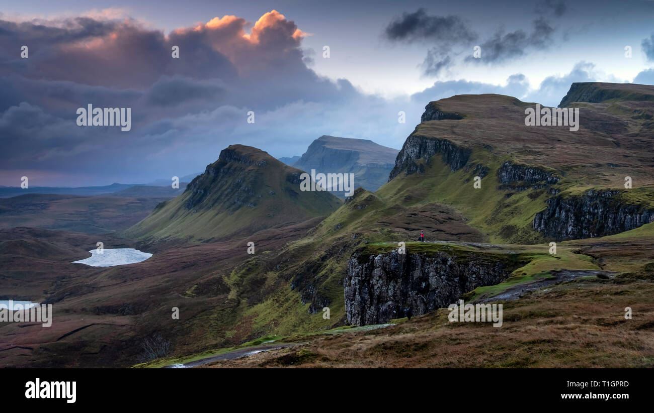A Photographer alone in the landscape shooting The Quiraing, Trotternish Peninsula, Isle of Skye, Inner Hebrides, Scotland, UK MODEL RELEASED Stock Photo
