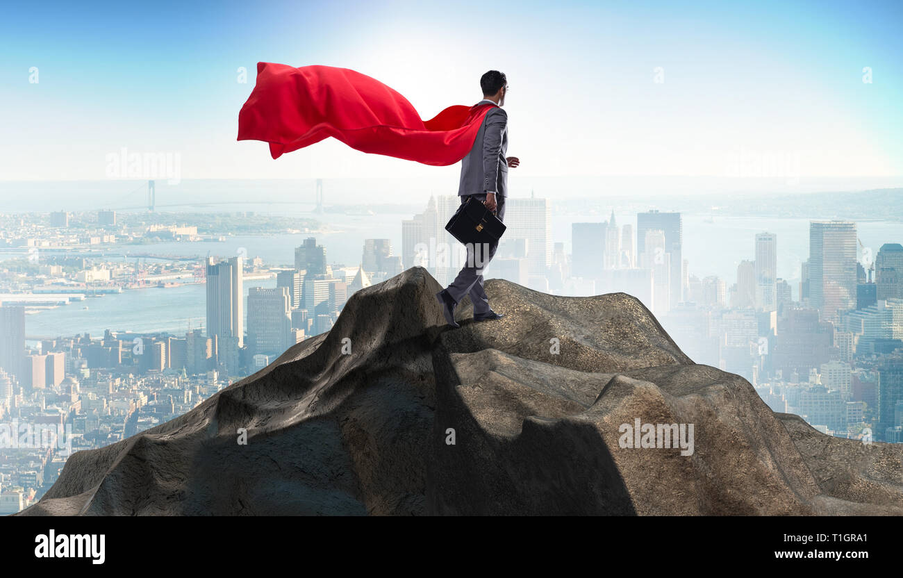 Superhero businessman on top of mountain Stock Photo - Alamy