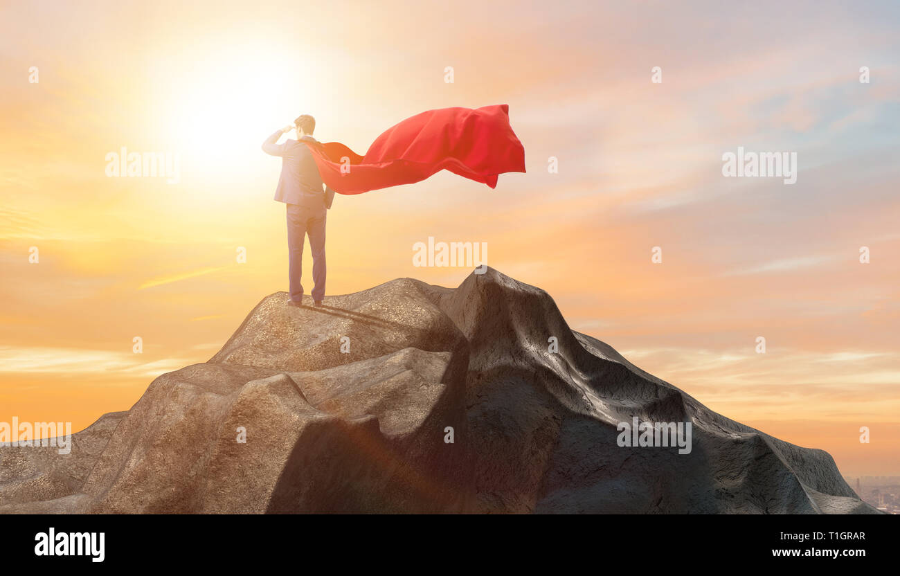 Superhero businessman on top of mountain Stock Photo - Alamy