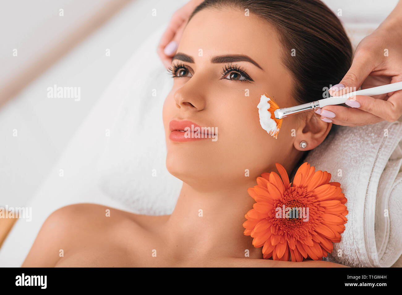 Pretty woman is getting a face mask Stock Photo