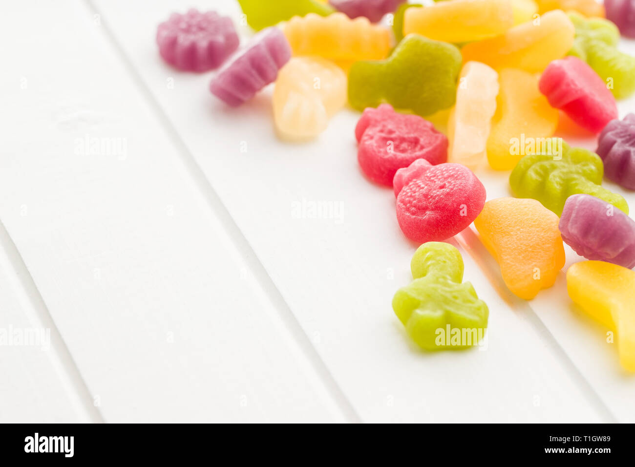 Fruit jelly candies on white table. Stock Photo