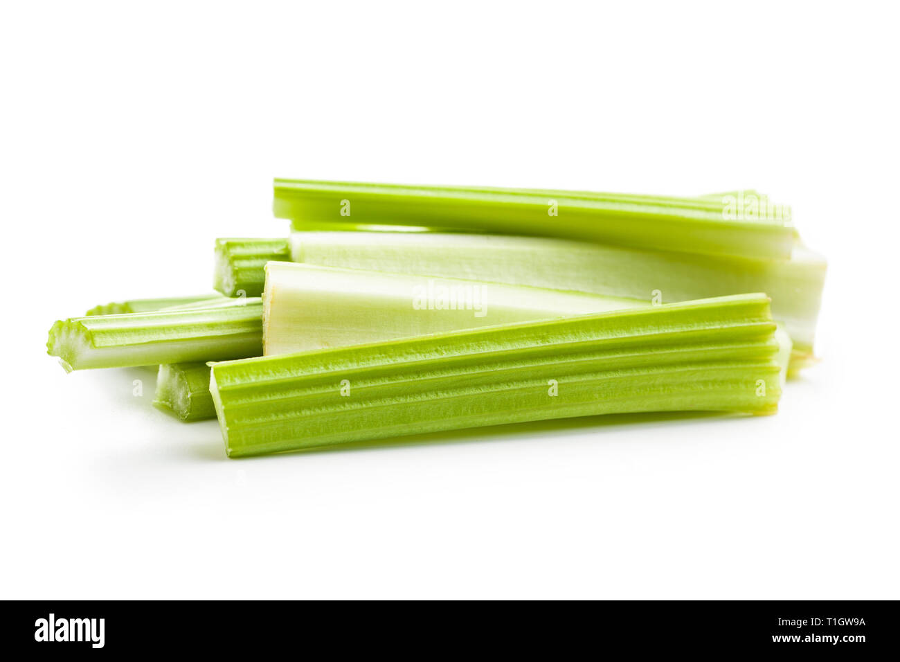 Celery sticks. Cutting celery stalks isolated on white background. Stock Photo