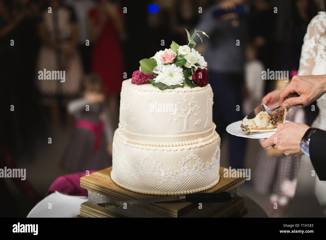 Bride and groom at wedding cutting the wedding cake Stock Photo