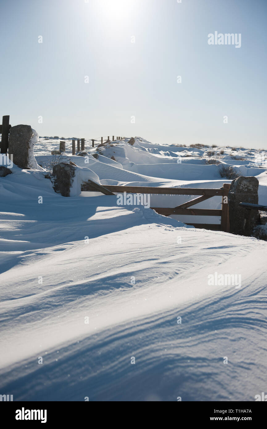 Five bar gate in a rural location buried in deep snow drift Stock Photo