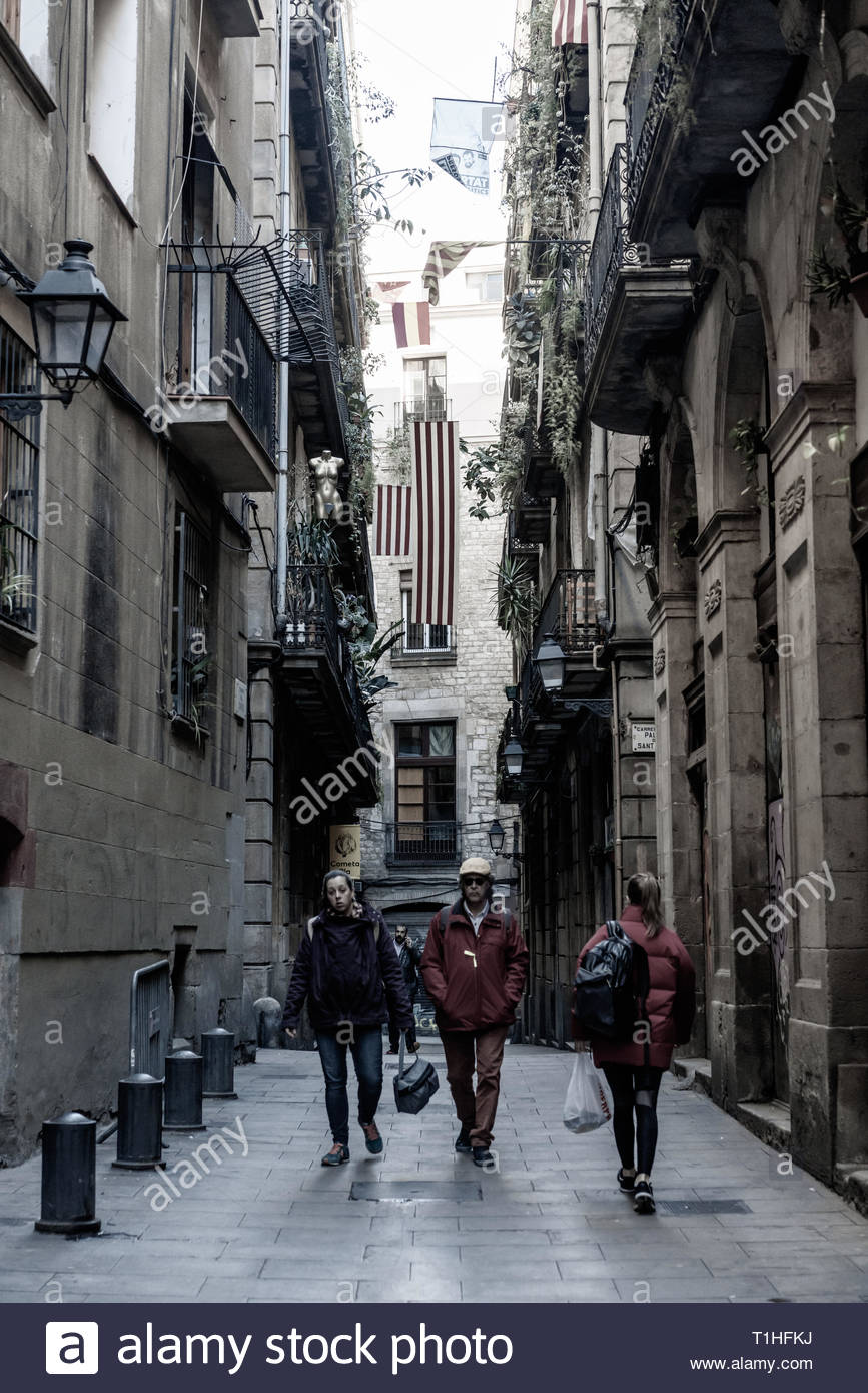 People Walking Through The Narrow Streets Of The Gothic Quarter Of Barcelona City Spain Stock Photo Alamy