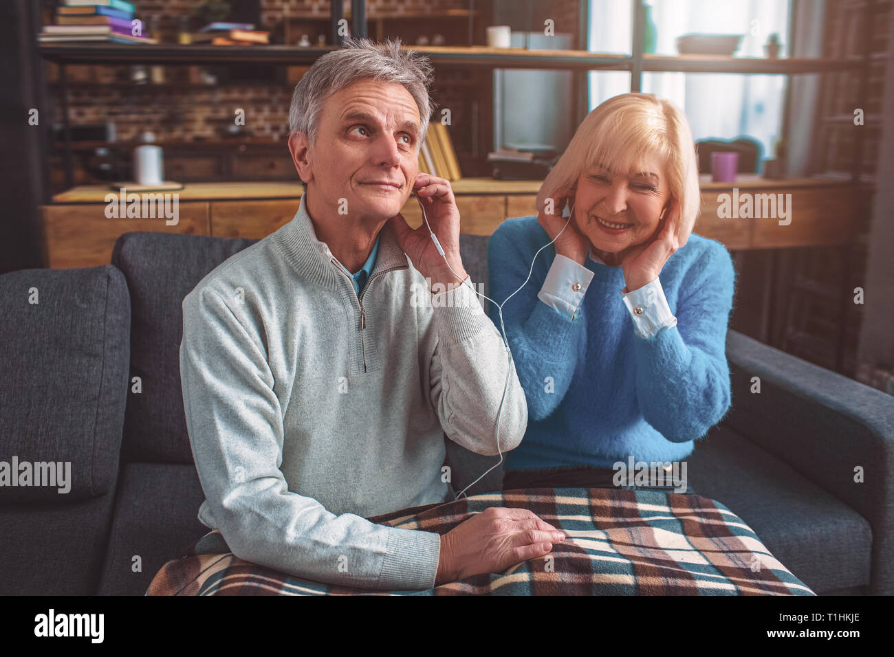 Old but beautiful people are listening to music through the head Stock Photo