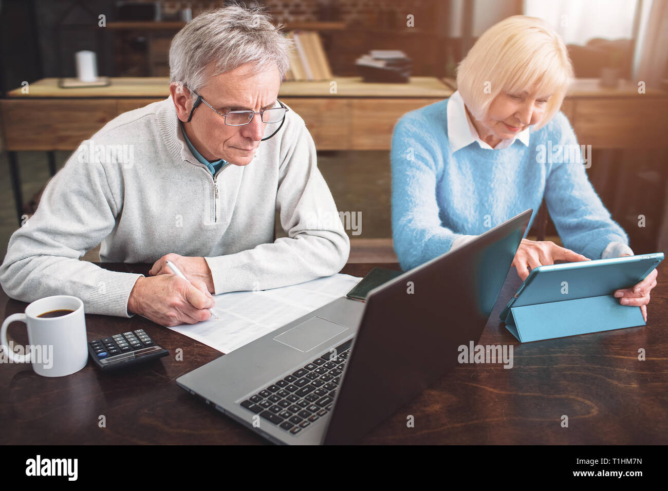 Old enterpreneur and his partner are working together on differe Stock Photo