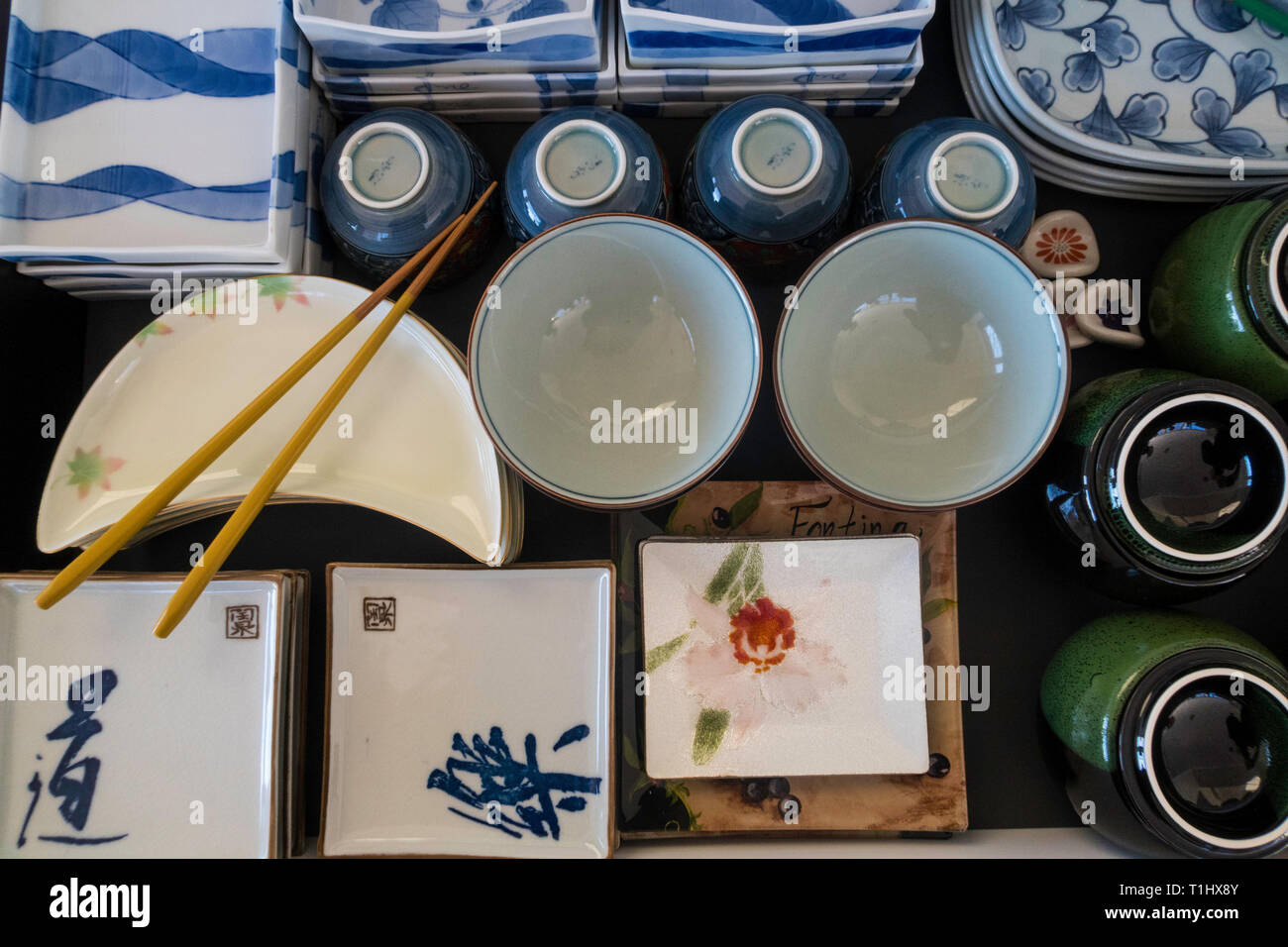 Stacked and organized Japanese plates of various shapes and sizes, USA Stock Photo