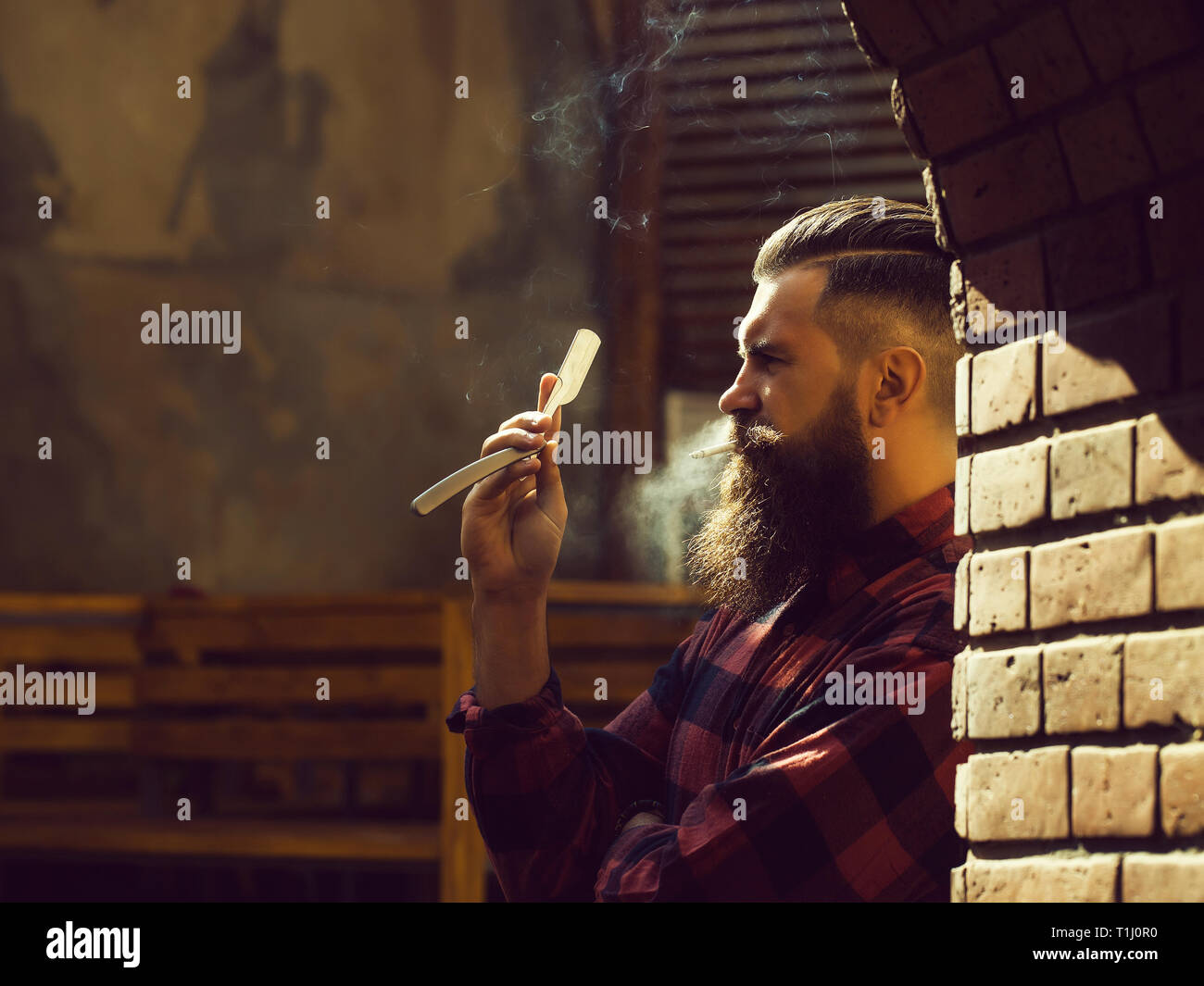 Hipster with cigarette and razor Stock Photo