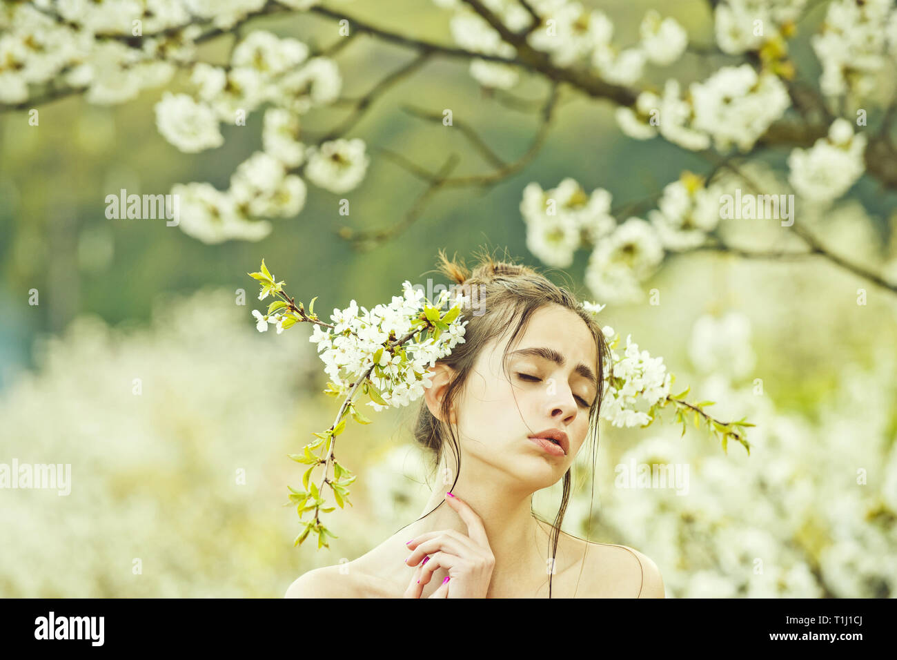 Cute girl with closed eyes and white flowers in hair Stock Photo - Alamy