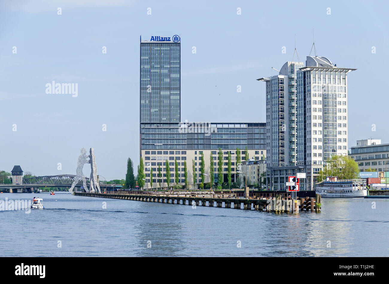 Berlin, Germany - April 22, 2018: River Spree with the high-Rise at the Elsenbruecke bridge, the building of the Allianz company, and Molecular Men Stock Photo