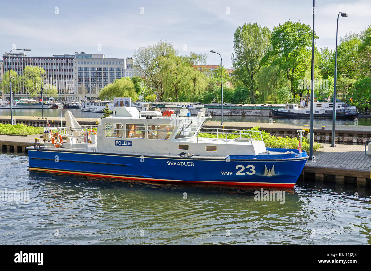Berlin, Germany - April 22, 2018: Water guard police boat entering the Multi-chamber Muehlendamm locks in the central Mitte district Stock Photo