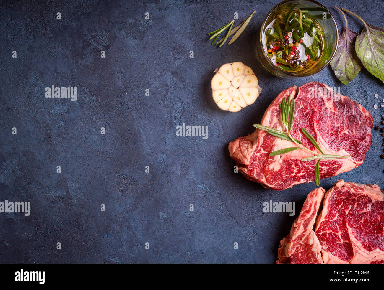 Raw meat steak on rustic concrete background ready to roasting Stock ...