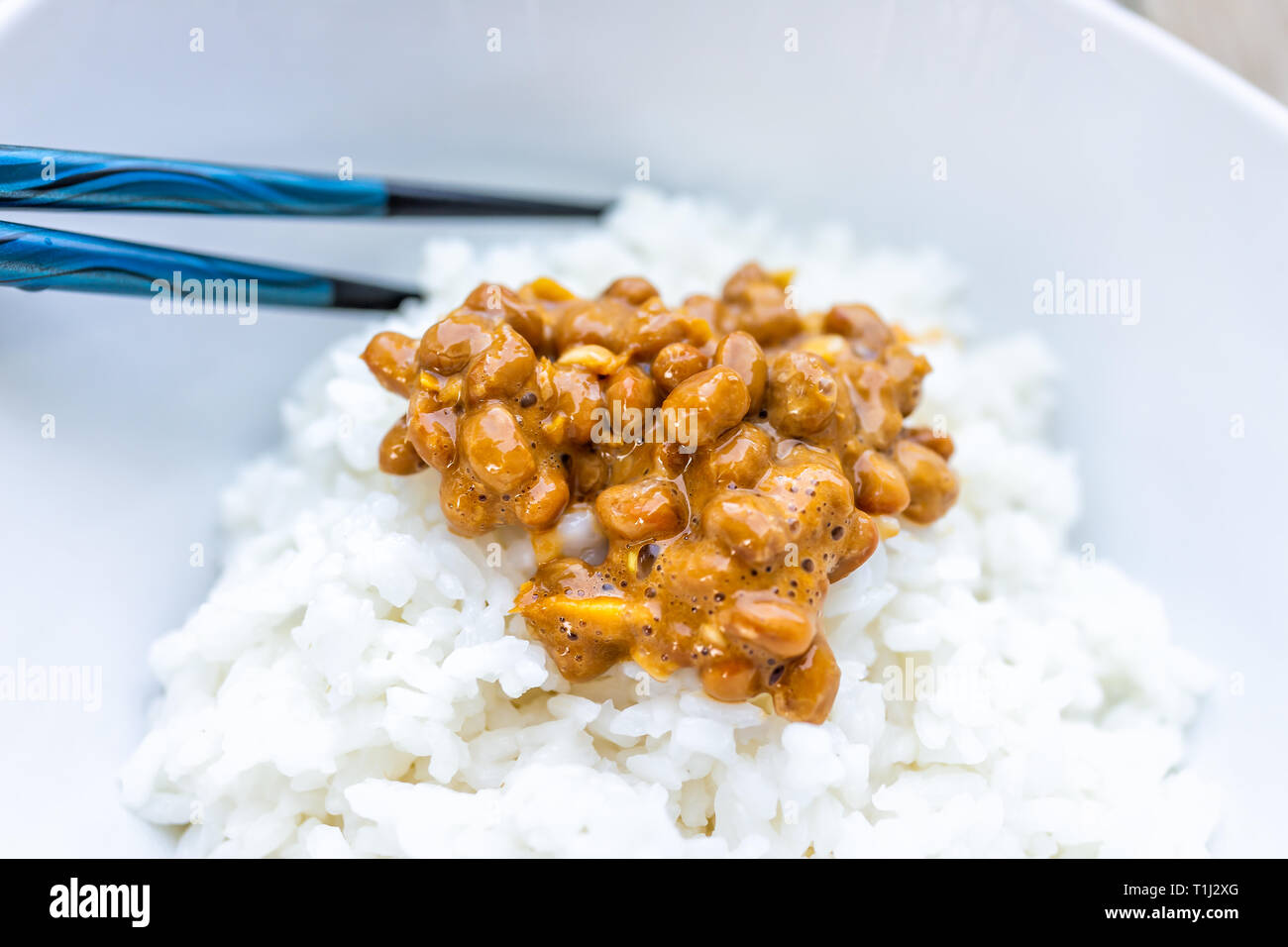 Closeup macro of pair of chopsticks on Asian Japanese natto fermented