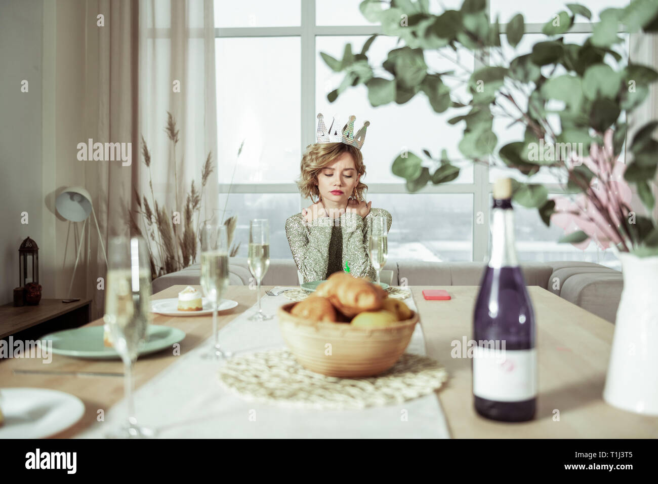 Beautiful birthday woman sitting at the table with no guests Stock Photo