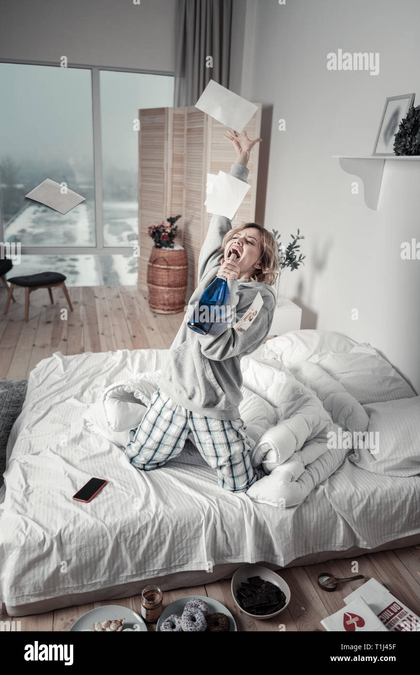 Woman going crazy after breakup while throwing photos Stock Photo Alamy