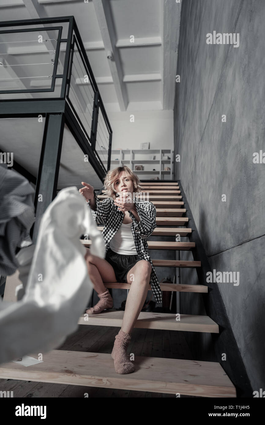 Woman feeling sentimental throwing clothes of ex away Stock Photo Alamy