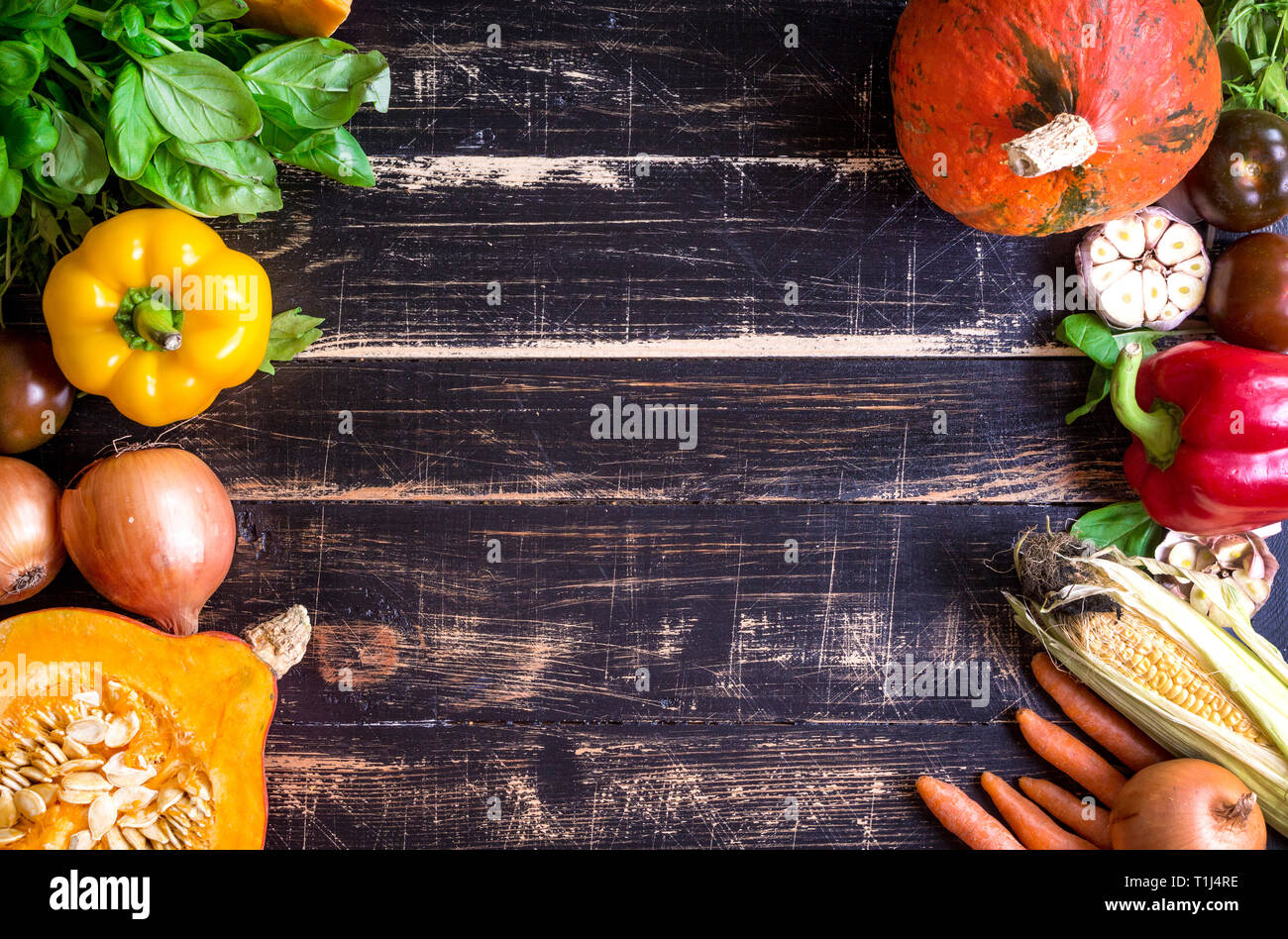 Fresh vegetables on a rustic dark textured table. Autumn background ...