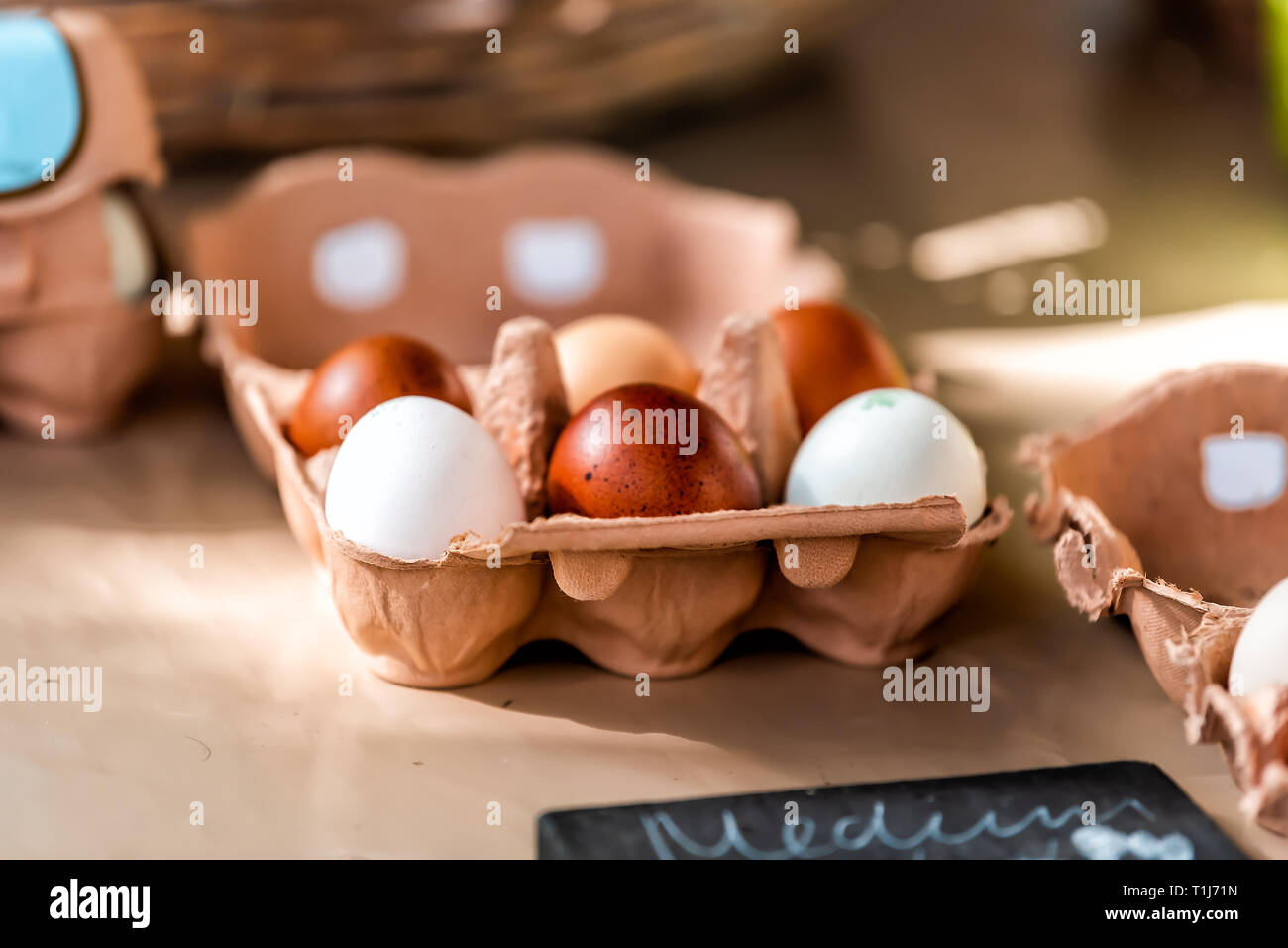 Closeup of tray of farm fresh brown and white multicolored eggs on display in farmer's market in London, UK Stock Photo