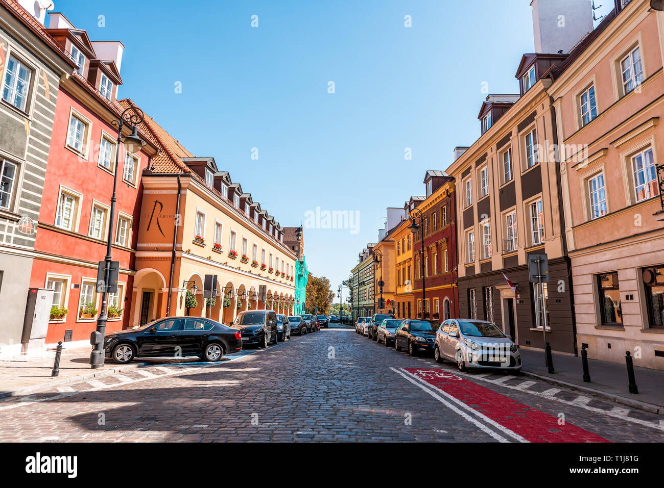 Warsaw, Poland - August 22, 2018: Famous old town in capital city during sunny summer day with nobody on cobblestone street alley and Le Regina hotel  Stock Photo