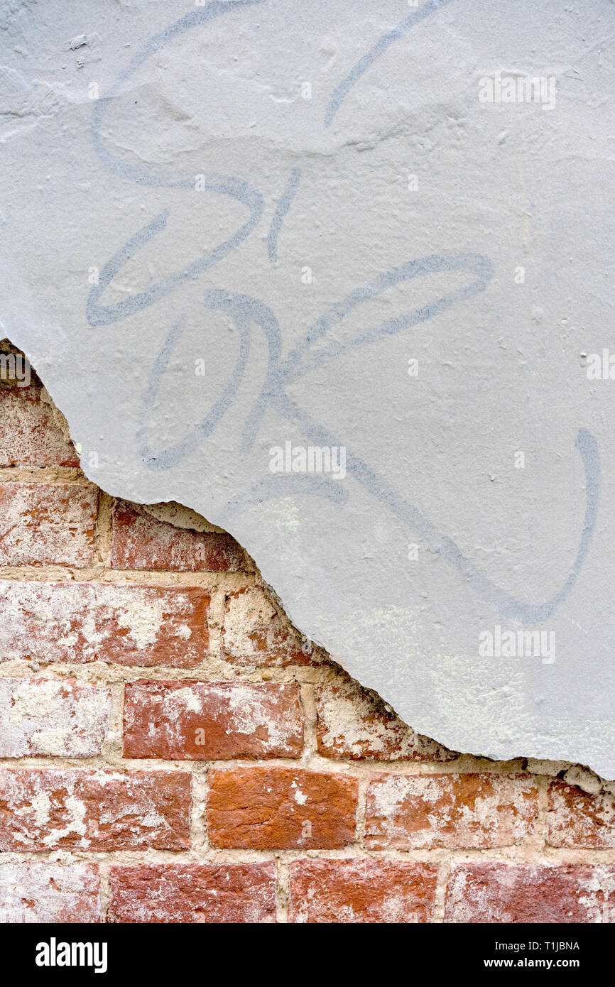 fragment of brick wall with damaged plaster Stock Photo - Alamy