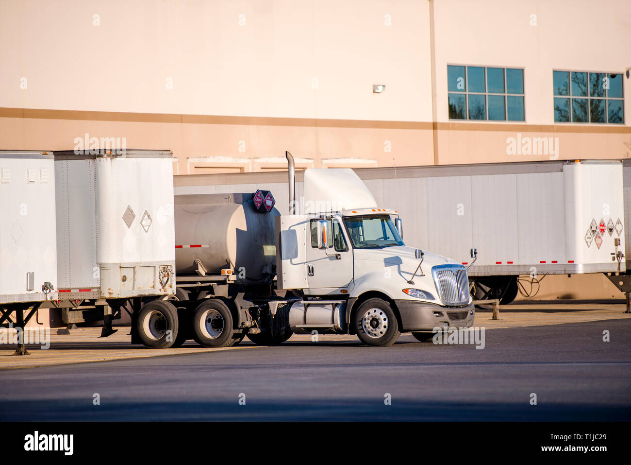 White big rig day cab semi truck for local deliveries with roof spoiler