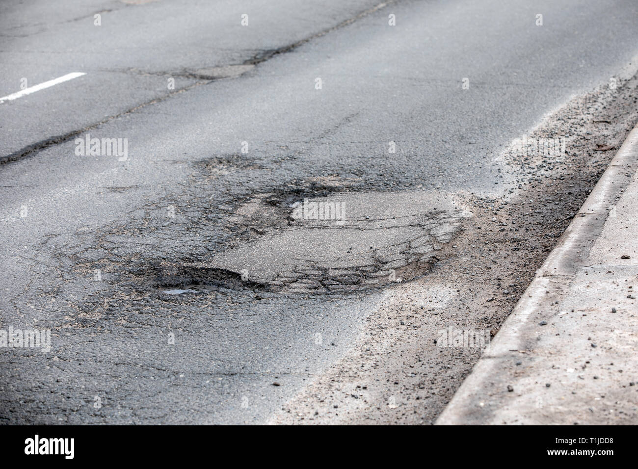 Damaged asphalt road with potholes Stock Photo Alamy