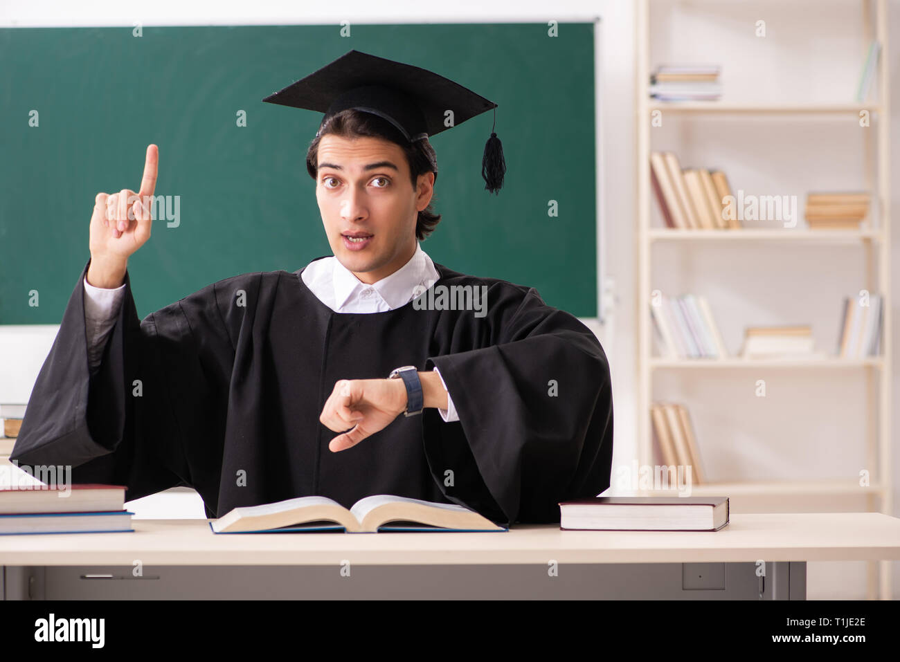 Graduate Board Students Graduate student in front of green board Stock Photo - Alamy
