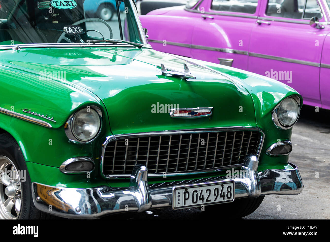 Havana, Cuba - 25 July 2018: The front end of a green classic Chevrolet Belair parked next to a purple classic car in Havana Cuba. Stock Photo