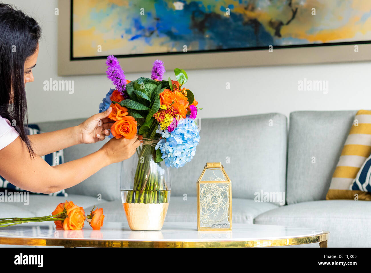 Woman arranging a bouquet of flowers Stock Photo