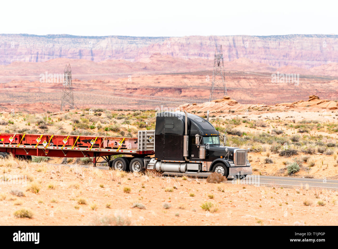 Black big rig American semi truck transports radioactive substances in ...
