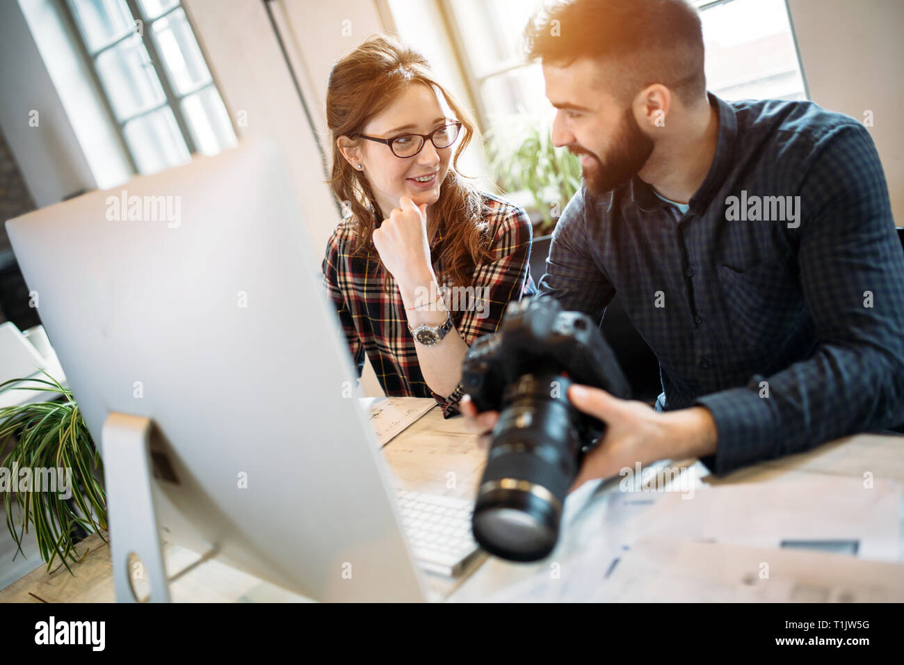 Two young designers working in modern office Stock Photo