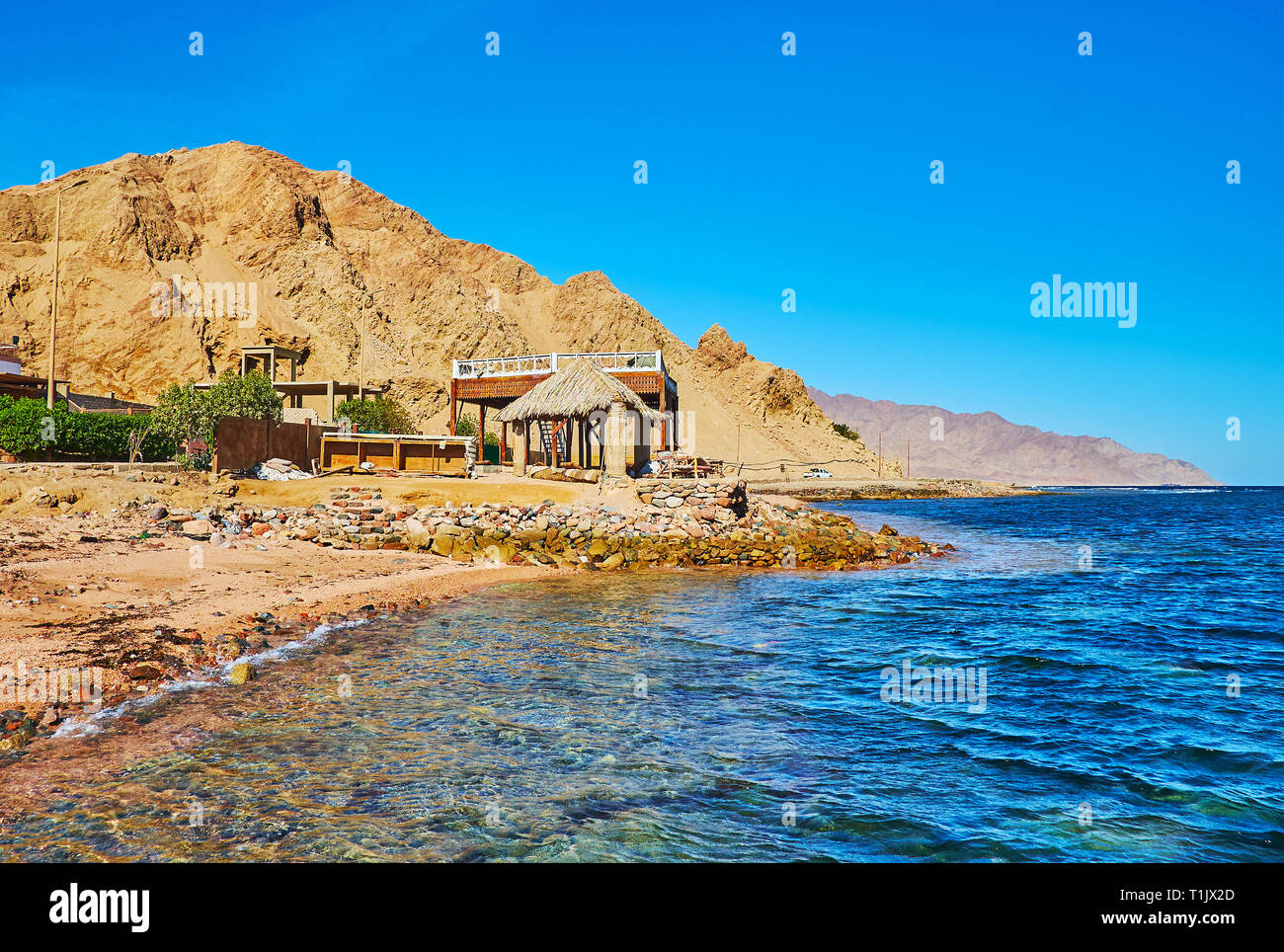 The red rocks of Sinai desert stretch along the shore of Aqaba gulf ...