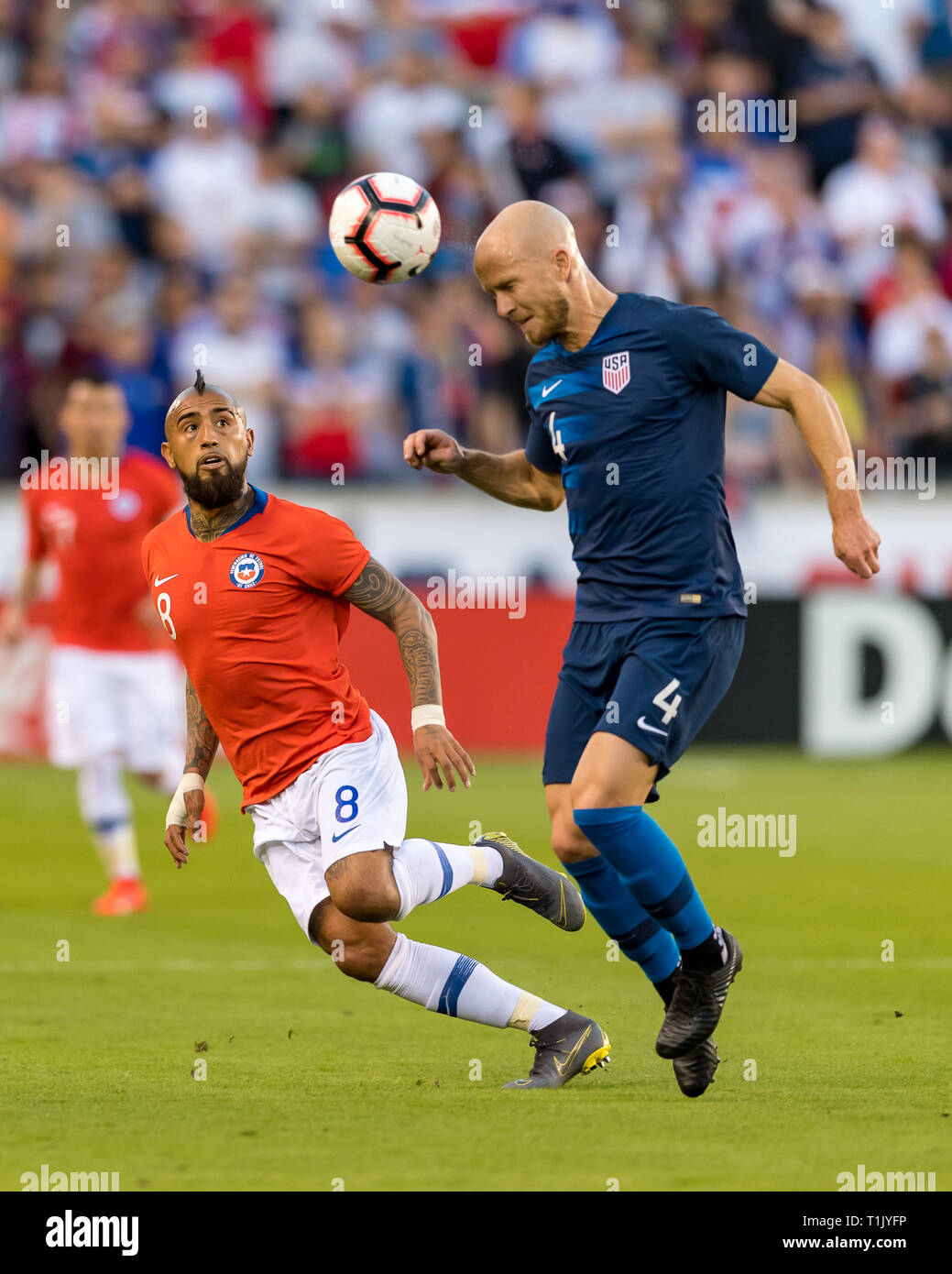 Houston, Texas, USA. 26th Mar 2019. USA midfielder Michael Bradley (4) heads the ball while Chile midfielder Arturo Vidal (8) anticipates the send during the second half of the international friendly match between USA and Chile at BBVA Compass Stadium in Houston, Texas The final ends in a tie 1-1 © Maria Lysaker/CSM. Credit: Cal Sport Media/Alamy Live News Stock Photo