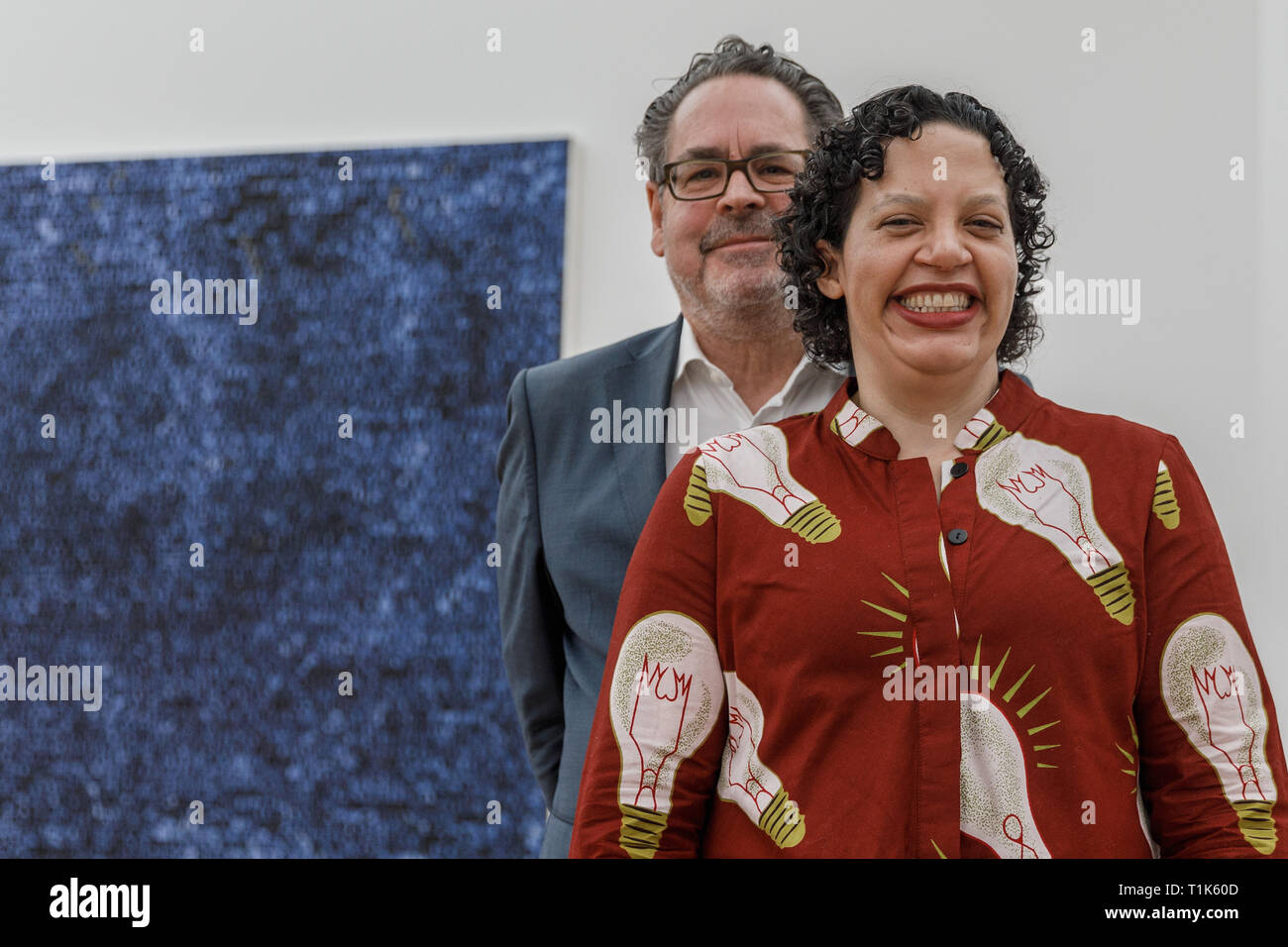 Berlin, Germany. 27th Mar, 2019. Udo Kittelmann (l), curator and director of the Nationalgalerie- Staatliche Museen zu Berlin, and Mirsini Amidon, daughter of the American painter Jack Whitten, stand in front of Jack Whitten's work 'Quantum Wall' in the exhibition 'Jack Whitten. Jack's Jacks' at the Hamburger Bahnhof - Museum für Gegenwart - Berlin. The US-American artist lived from 1939 to 2018. The exhibition is on view from 29.03.2019 to 01.09.2019. Credit: Carsten Koall/dpa/Alamy Live News Stock Photo