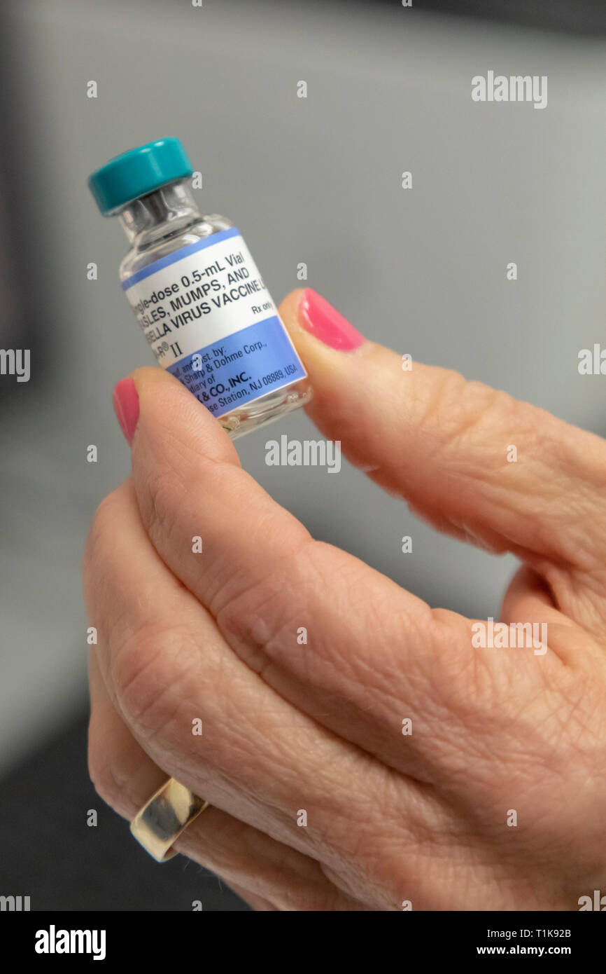 Southfield, Michigan, USA. 27th Mar, 2019. A nurse holds a vial of the MMR vaccine at the Oakland County Health Department, which protects against measles, mumps, and rubella. The health department is urging vaccinations since 22 measles cases have been confirmed following the visit of an infected traveler from Israel. Credit: Jim West/Alamy Live News Stock Photo