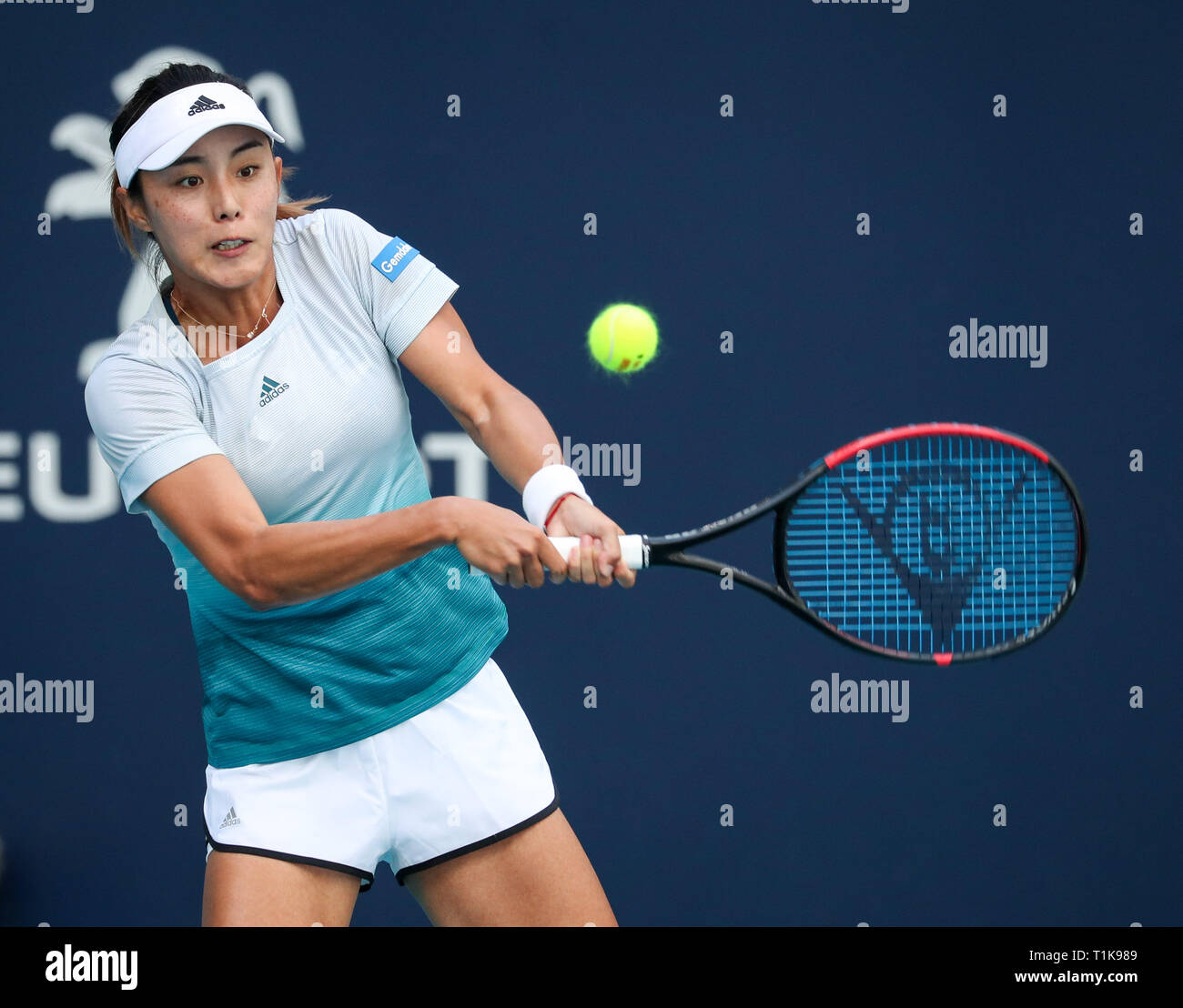 Miami Gardens, Florida, USA. 27th Mar, 2019. Qiang Wang, of China, returns a shot to Simona Halep, of Romania, during a quarter-finals match at the 2019 Miami Open Presented by Itau professional tennis tournament, played at the Hardrock Stadium in Miami Gardens, Florida, USA. Mario Houben/CSM/Alamy Live News Stock Photo