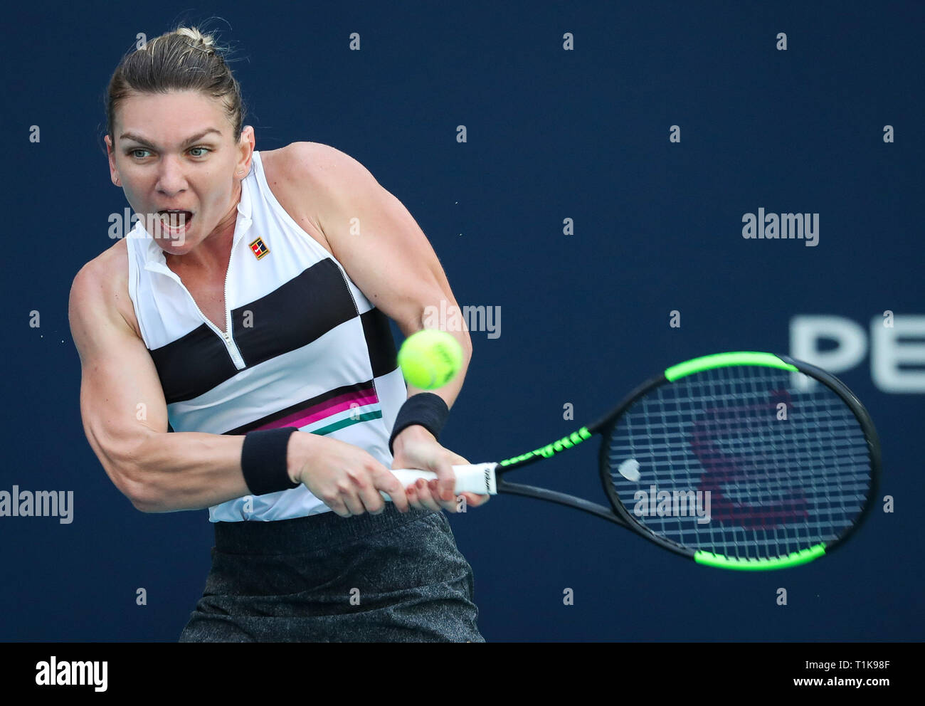 Miami Gardens, Florida, USA. 27th Mar, 2019. Simona Halep, of Romania, returns a shot to Qiang Wang, of China, during a quarter-finals match at the 2019 Miami Open Presented by Itau professional tennis tournament, played at the Hardrock Stadium in Miami Gardens, Florida, USA. Halep won 6-4, 7-5. Mario Houben/CSM/Alamy Live News Stock Photo