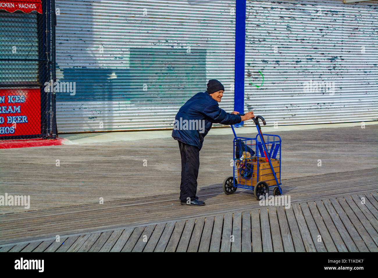 Lonely senior citizen is walking on the boardwalk. Brooklyn, NY Spring 2019 Stock Photo