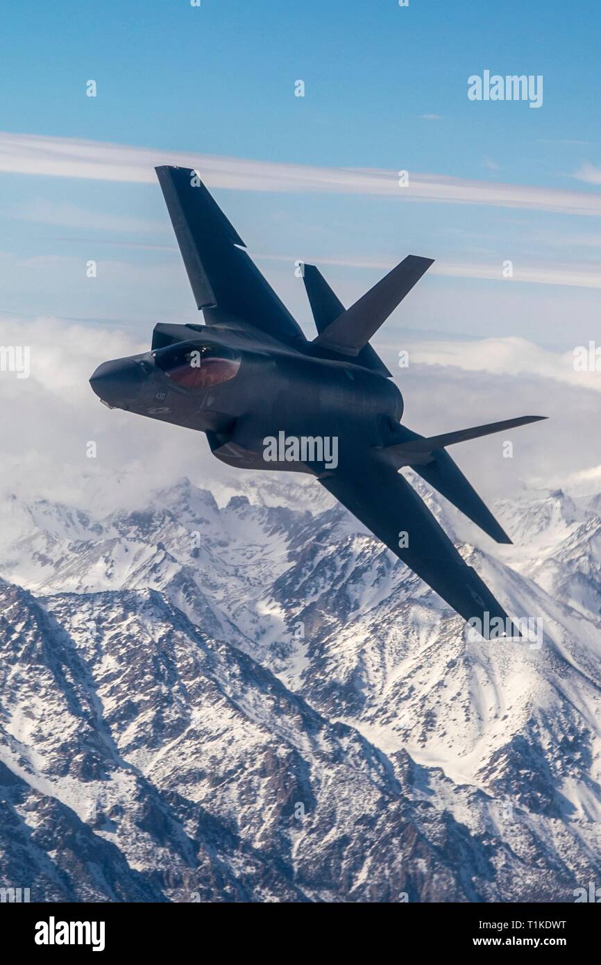 A U.S. Navy F-35C Lightning II stealth fight aircraft with Strike Fighter Squadron 125 fly in formation over the Sierra Nevada mountains during a training exercise February 28, 2019 over Lemoore, California. Stock Photo