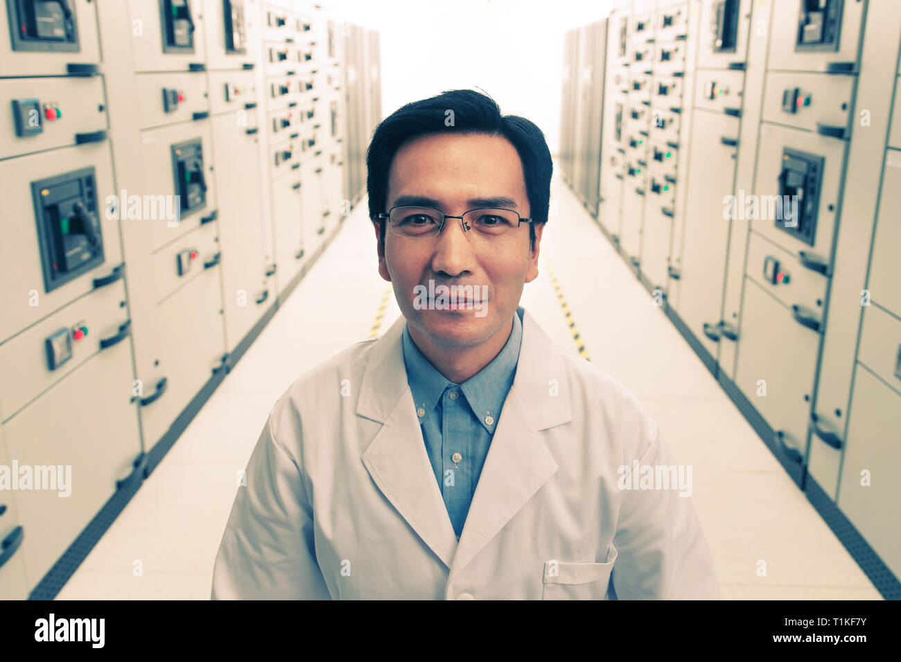 Technical personnel in the voltage room work Stock Photo