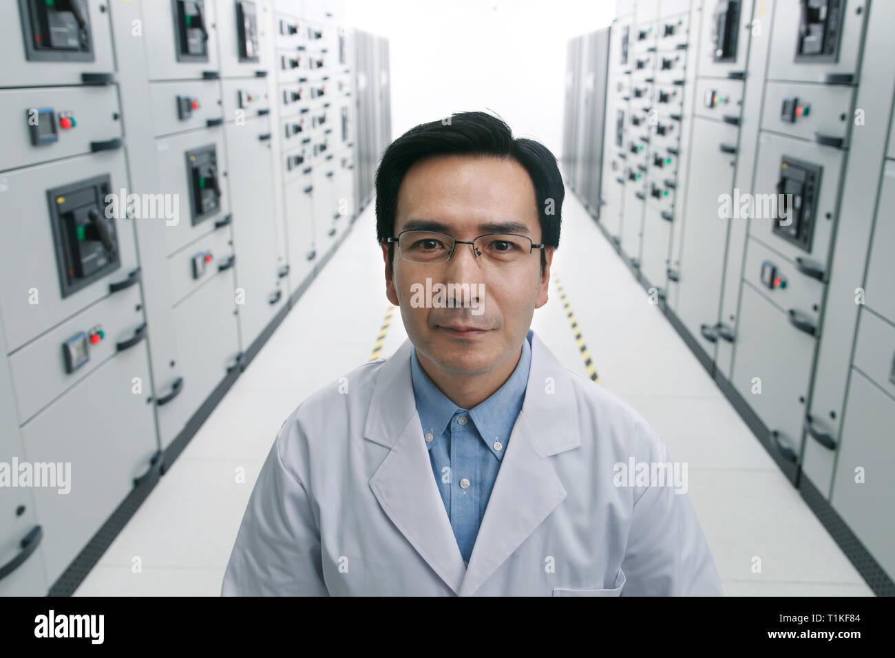 Technical personnel in the voltage room work Stock Photo