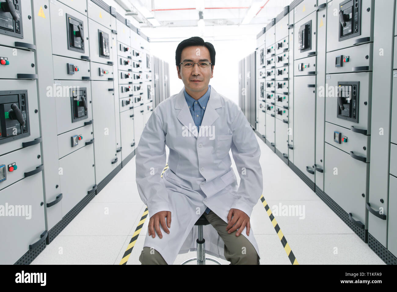 Technical personnel in the voltage room work Stock Photo