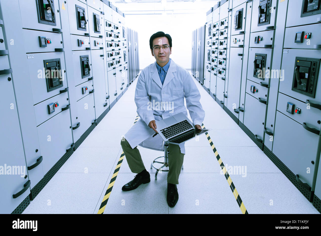Technical personnel in the voltage room work Stock Photo