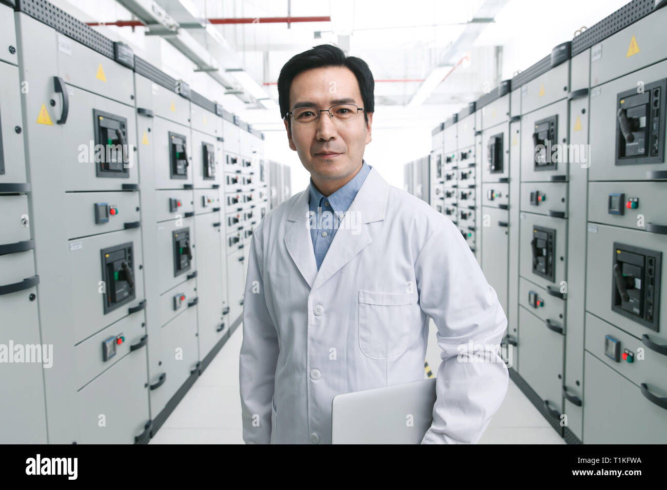 Technical personnel in the voltage room work Stock Photo