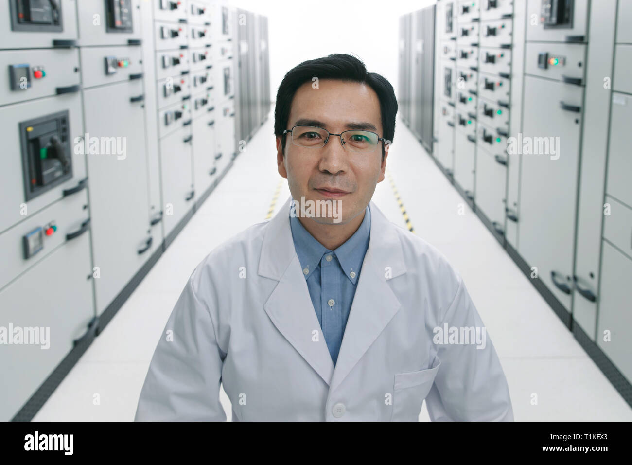Technical personnel in the voltage room work Stock Photo