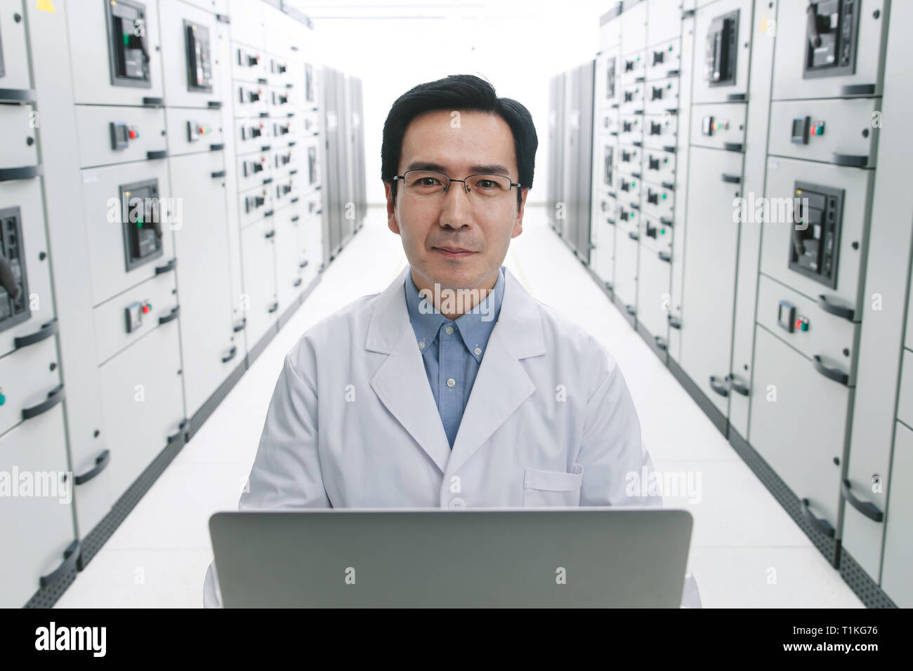 Technical personnel in the voltage room work Stock Photo