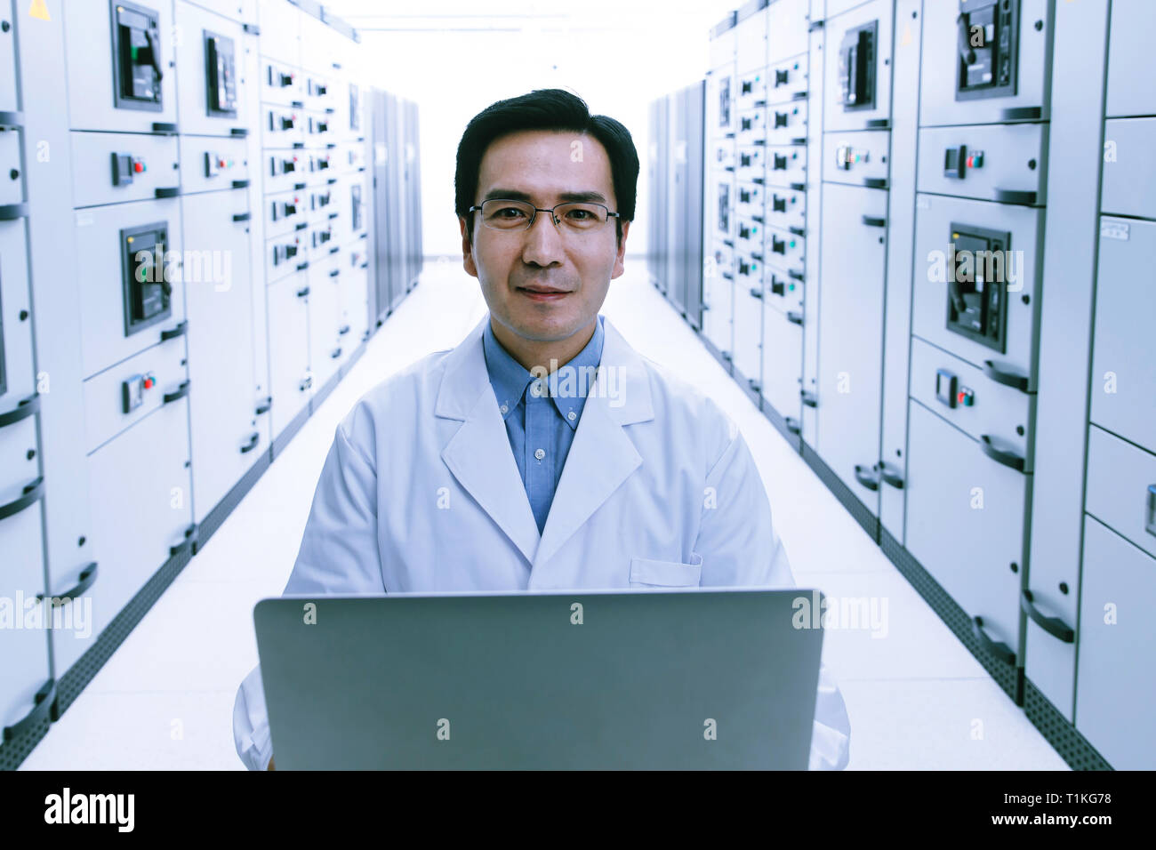 Technical personnel in the voltage room work Stock Photo